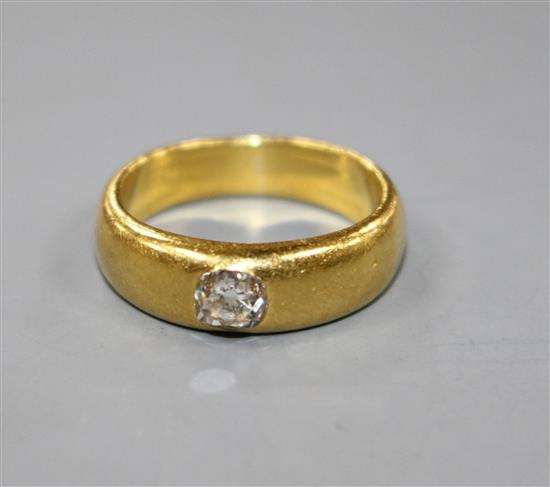 A yellow metal (tests as 18ct) and gypsy set solitaire diamond ring, size I/J.